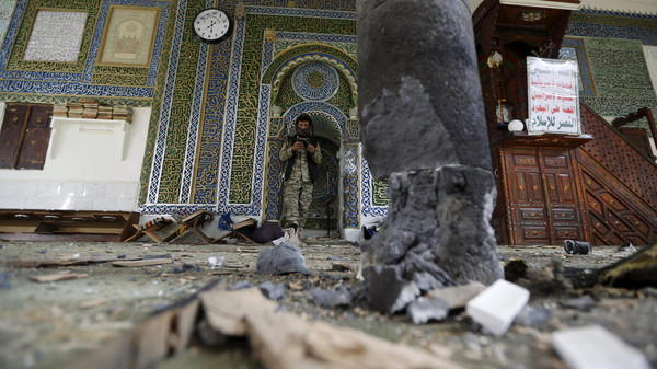 Houthi militant stands inside the al-Balili mosque after two bombings hit the mosque in Yemen's capital Sanaa