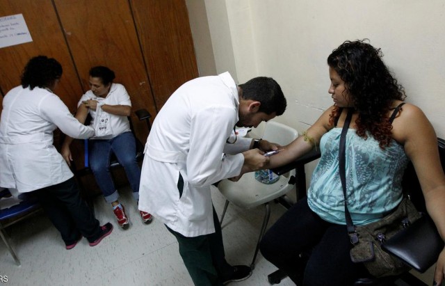 Health personnel extract blood from pregnant women as part of a general routine check, which includes examination for mosquito-borne viruses like Zika, at the maternity ward of the Hospital Escuela in Tegucigalpa