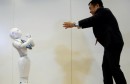 Board Director of Product Division for SoftBank Robotics Hasumi performs with SoftBank's emotion-reading robot Pepper during a demonstration in Tokyo