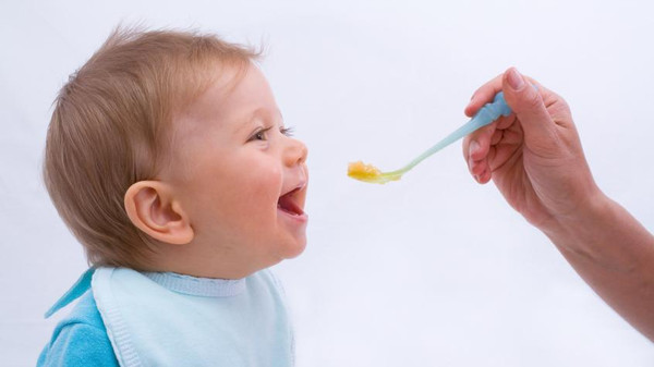 Portrait of Baby Being Fed